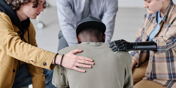 A group offers support to a person in distress, showing empathy and care.