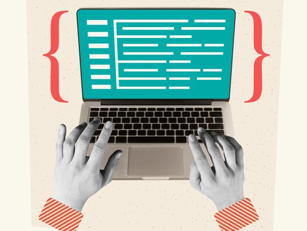 Hands typing code on a laptop with curly braces on sides.