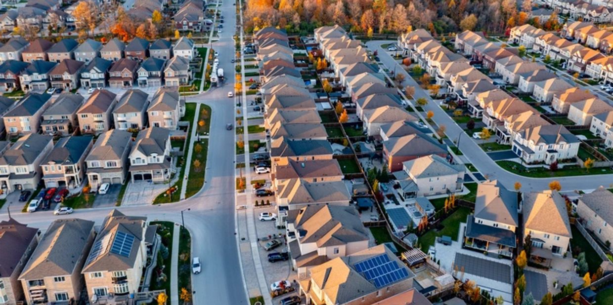 A suburban neighborhood with houses and autumn trees. first time home buyers.
