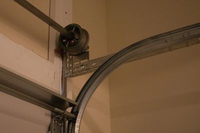 Garage door hinges and bearing plates: metal connectors and supports on door panels.