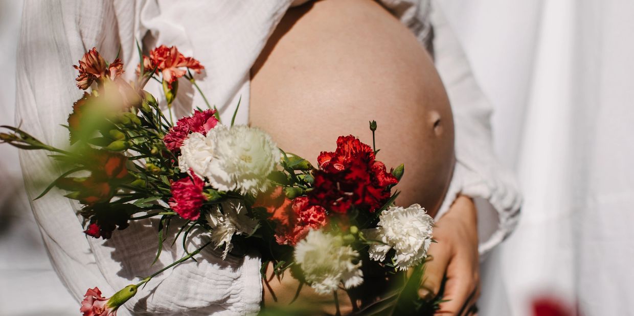 Pregnant belly with colorful flowers.