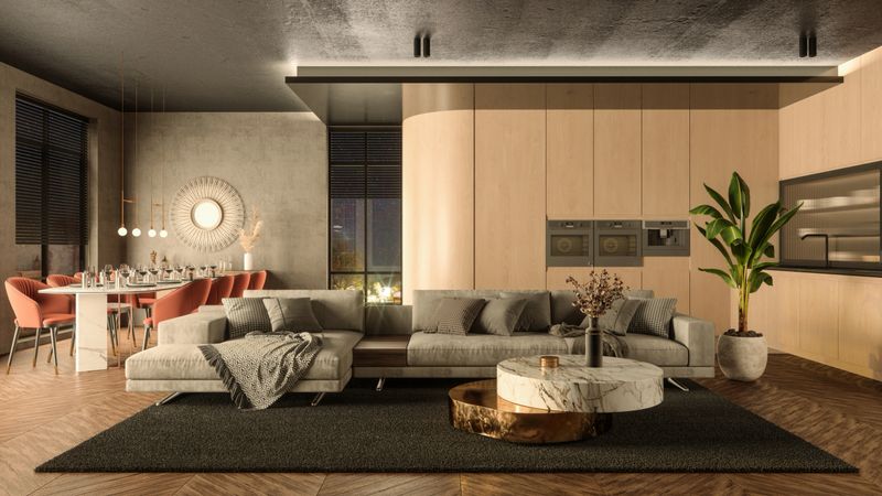 Modern Open Plan Home Interior With Corner Sofa, Dining Space And Kitchen