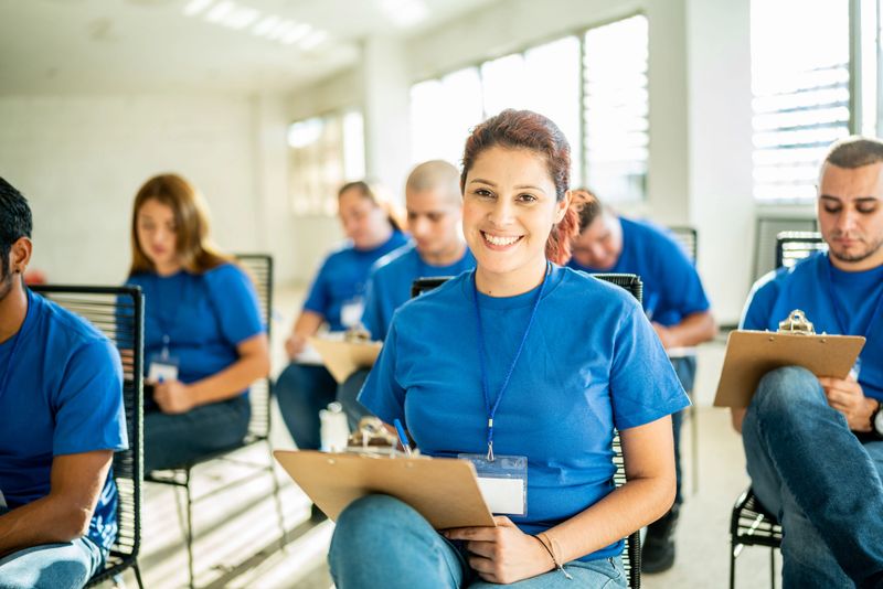 Portrait of volunteer mid adult woman during a meeting at community center