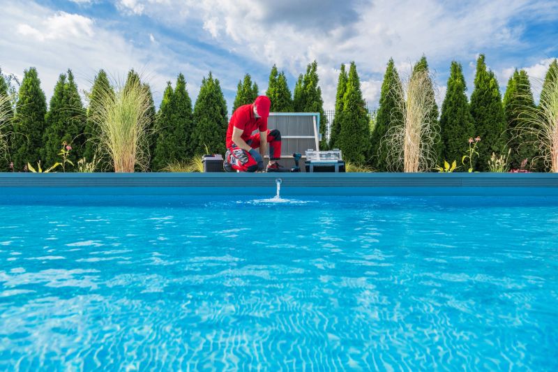 Professional Caucasian Swimming Pools Technician in His 40s Performing Seasonal Maintenance. Outdoor Residential Backyard Pool.