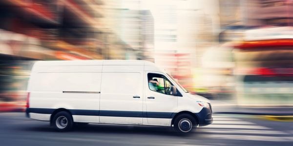 Modern delivery van on city street.