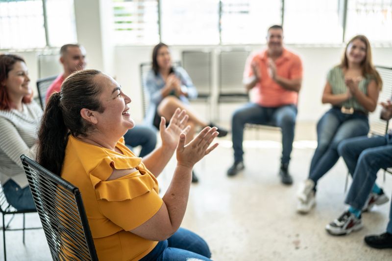 Mid adult woman applauding during a presentation