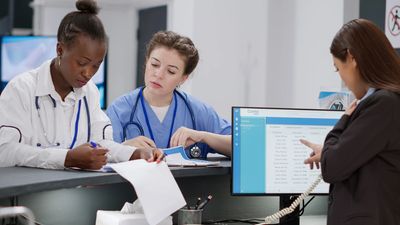 Medical staff reviewing documents in a hospital.