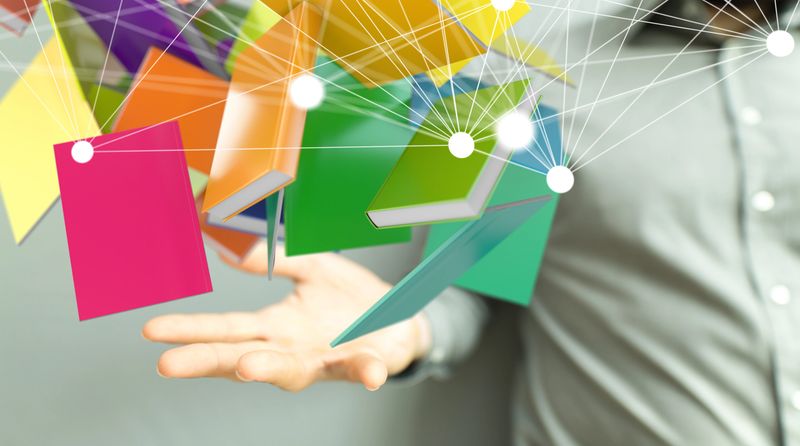 The colorful notebooks connected to each other and a man holding it-international education