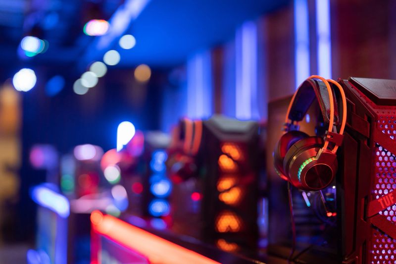 illuminated interior of esports cybercafe with video game competition setup.