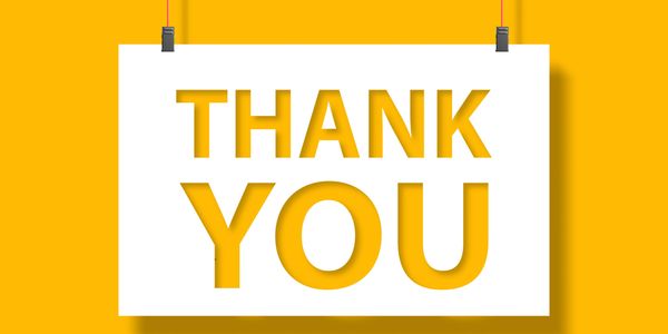 Thank you text on a hanging sign with yellow background.