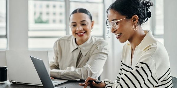 Two business people looking at a laptop screen