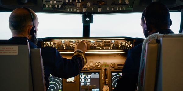 Pilots in the cabin flying one of Bare Jet's aircraft emphasizing safety during an empty leg flight
