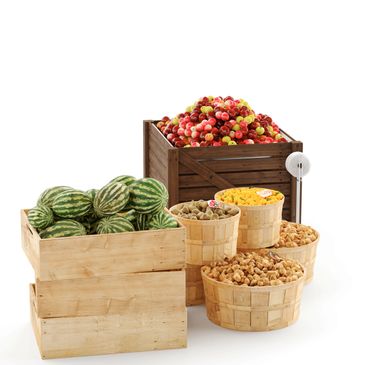 Various fruits and nuts displayed in wooden crates and baskets.