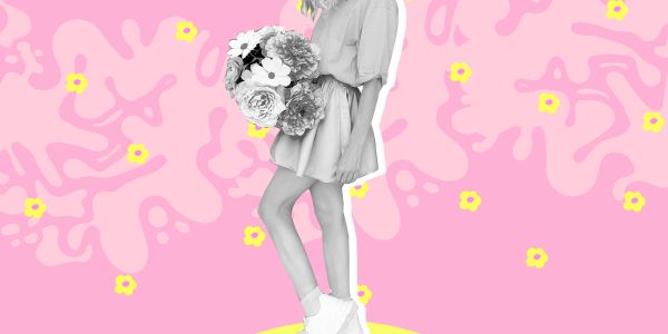 A stylish woman holding flowers against a vibrant pink background with yellow accents.