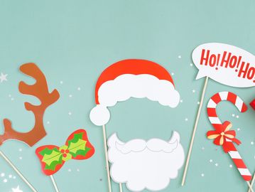 Christmas-themed photo booth props including Santa hat, beard, candy cane, and reindeer antlers.