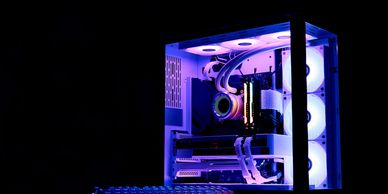Custom RGB gaming PC with illuminated components inside a modern case.