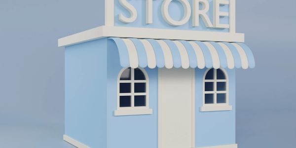 A small blue and white store with an awning and windows.