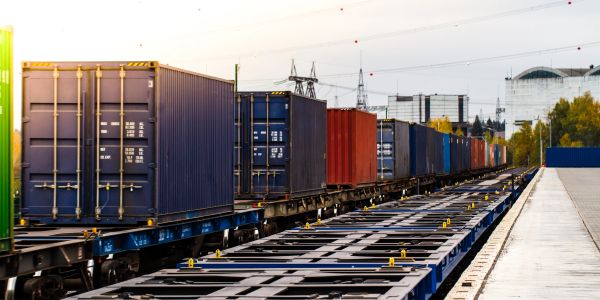 Freight train carrying colorful shipping containers.