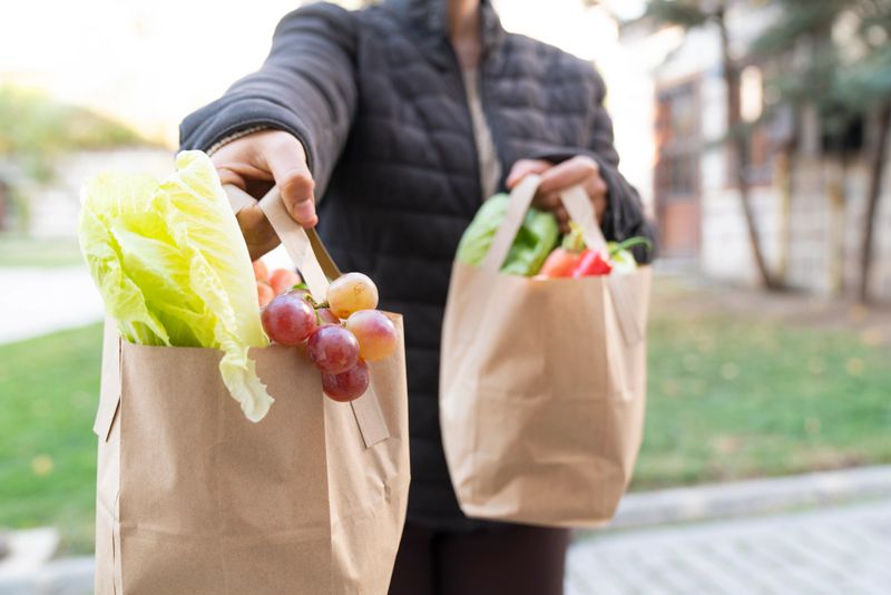 Volunteer Delivering Food To Elderly People During Lockdown