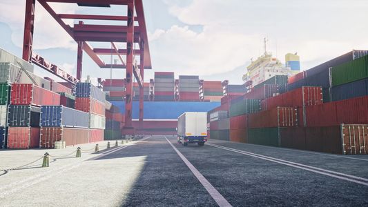 Container terminal with stacked cargo containers and a truck.