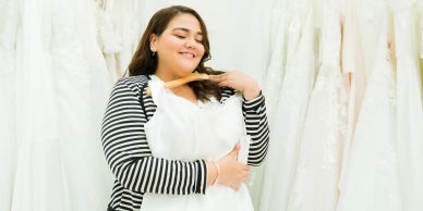 Woman happily choosing a wedding dress.