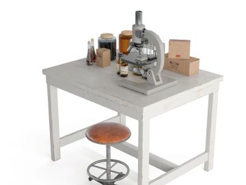 A microscope on a white table with some bottles and a stool.