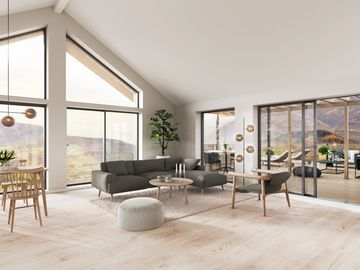 Modernes Wohnzimmer mit großen Fenstern und neutralem Design.