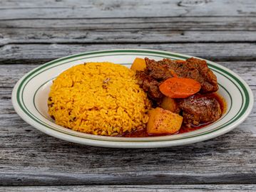 Plate of rice with stewed meat and vegetables.