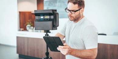 Man using a tablet with a camera setup.