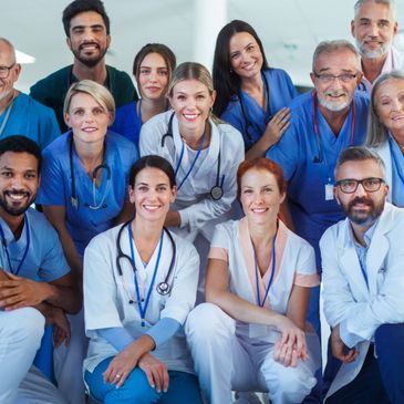 A diverse group of smiling healthcare professionals posing together.
