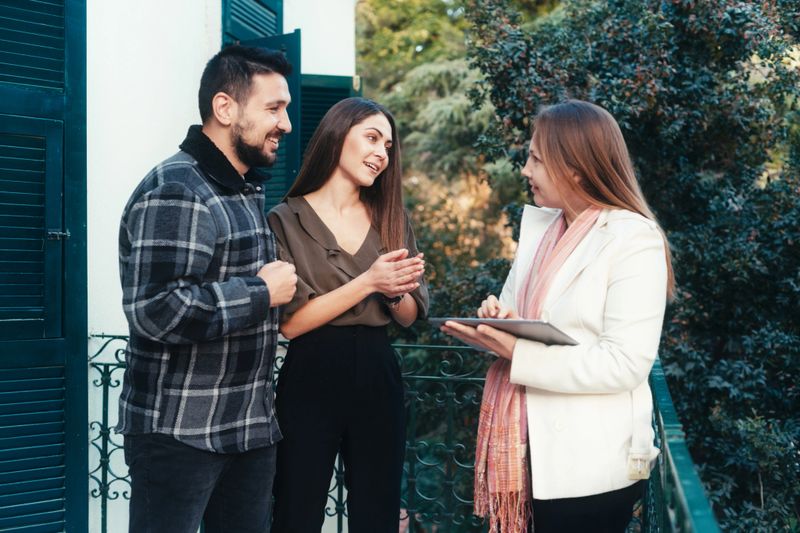 Real estate agent with a young couple in a new house