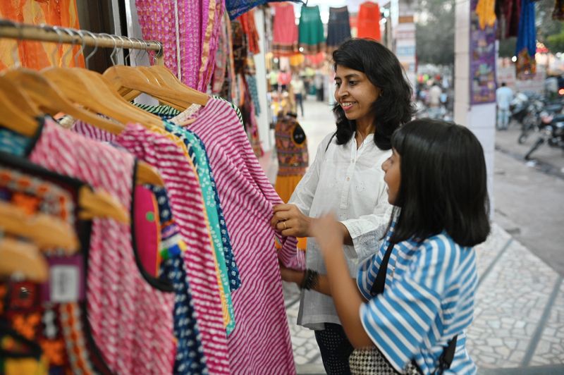Tourist Mother and Daughter shopping at a local street market, Jodhpur Rajasthan