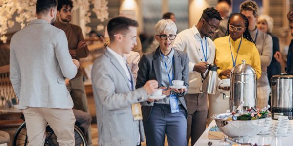 People socializing and enjoying coffee at an event.