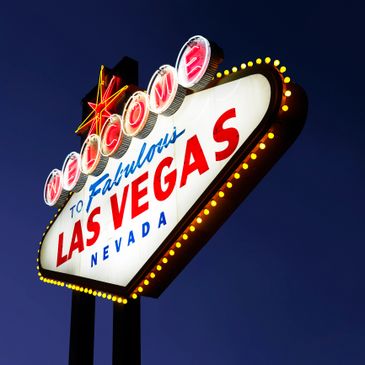 Iconic illuminated Welcome to Fabulous Las Vegas sign against dark sky.