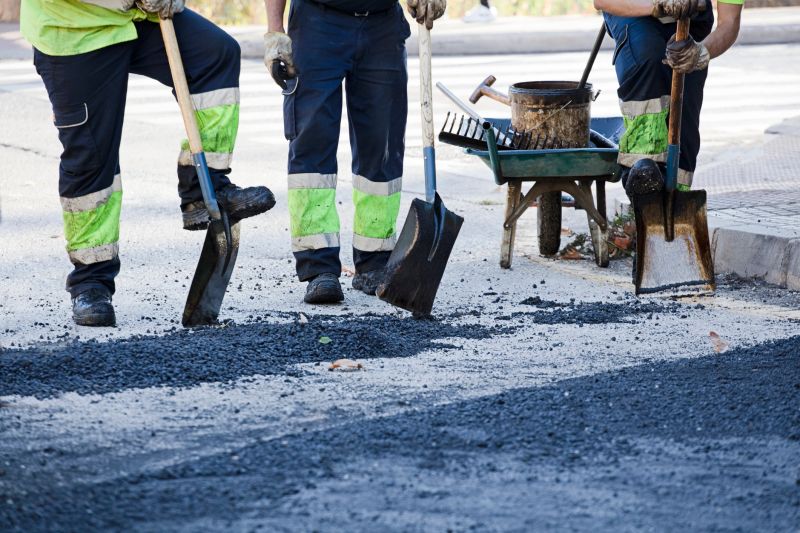 road construction workers, asphalt smoothing