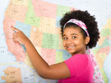 Smiling girl pointing at California on a US map.