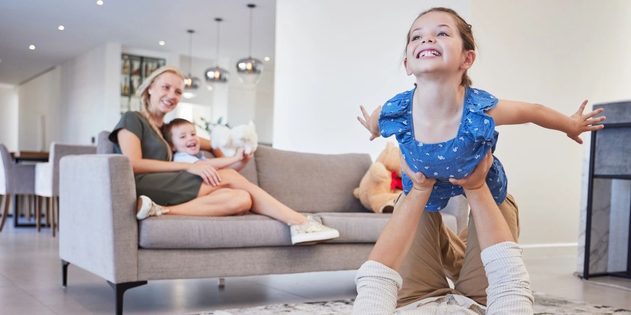 Family spending time together in a clean, organized living room after expert house cleaning