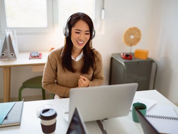 Woman having a video call with headphones on.