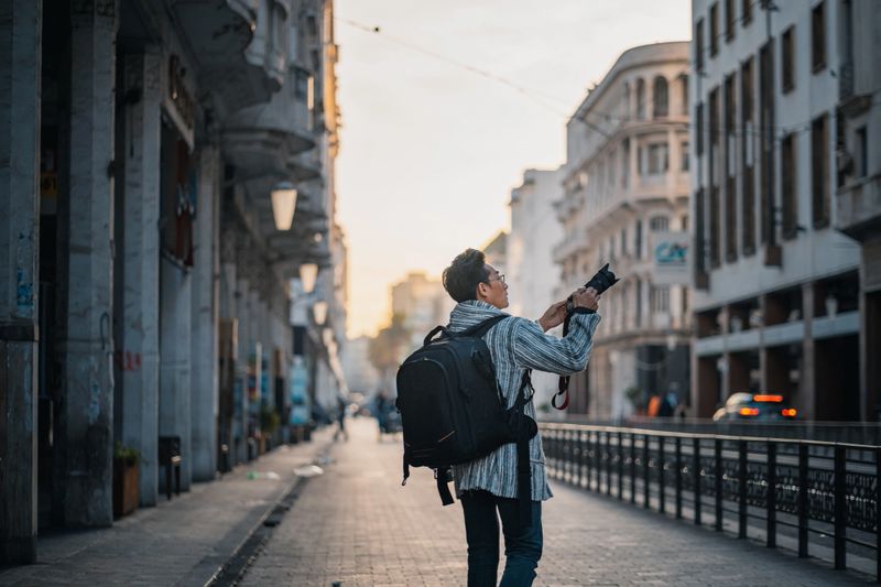 Asian Chinese man tourist photographing exploring Casablanca, Morocco in the morning