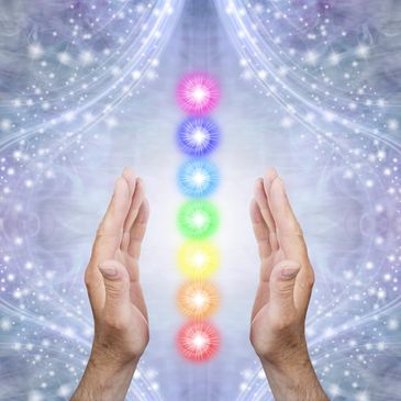 Hands channeling energy through vibrant chakra colors against a mystical background.