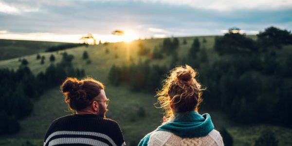 Couple enjoying sunset in the countryside.