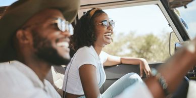 Two friends joyfully driving on a sunny day.