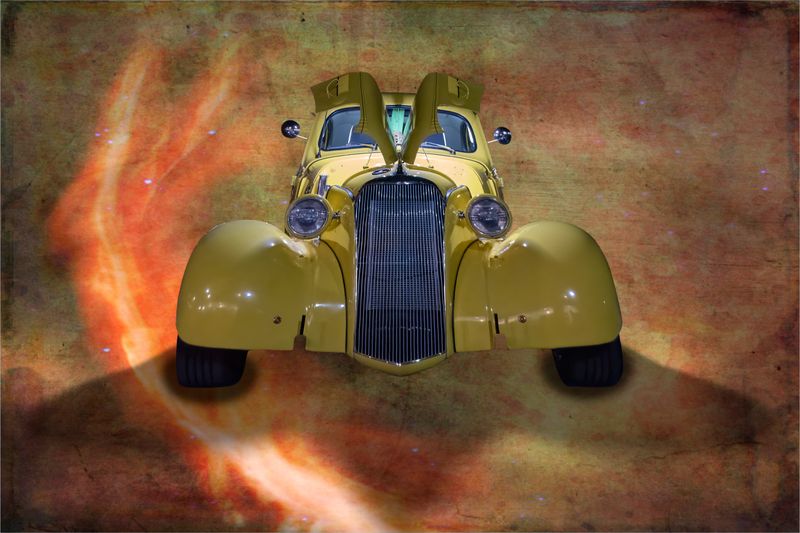 A portrait of a yellow 1930s Chevrolet against a textured background with a flame effect on the left side.