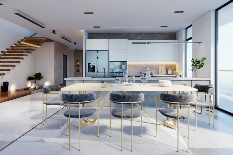 Luxury Home Interior With  Staircase, Refrigerator And Dining Table