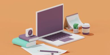 Workspace setup with laptop, books, calendar, coffee, and stationery.