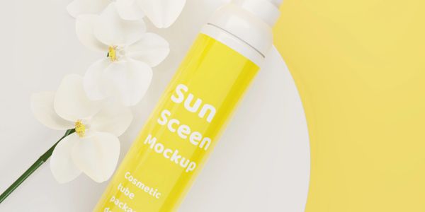 Yellow sunscreen tube mockup with white flowers on a white and yellow background.