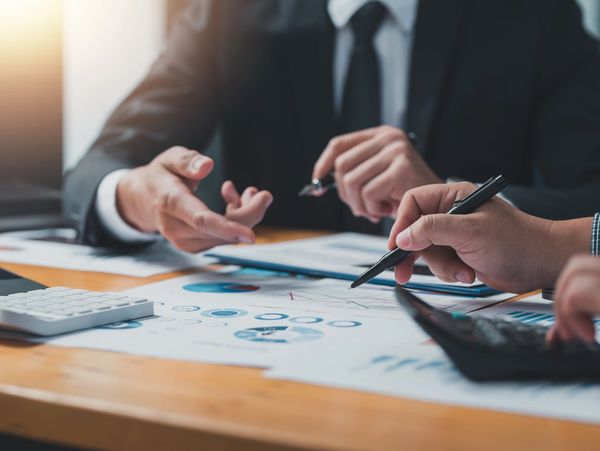 Business professionals analyzing charts and data during a meeting.