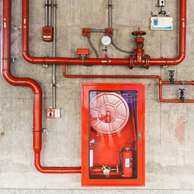 Red fire safety system setup on wall.