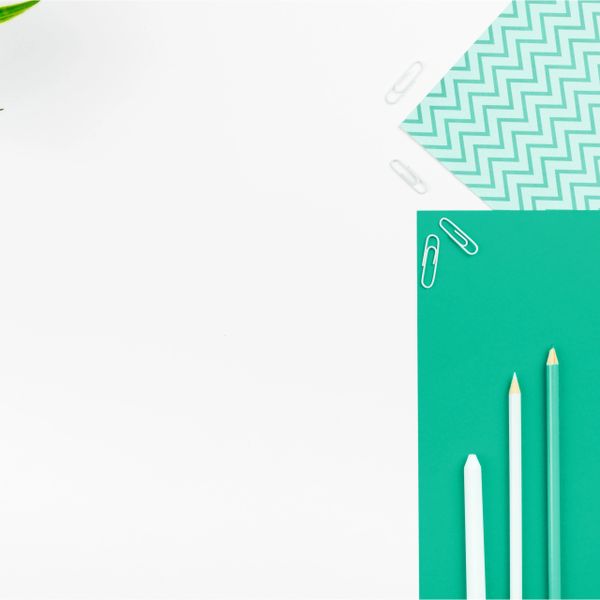 Minimalist flat lay of stationery with pencils and paper clips.