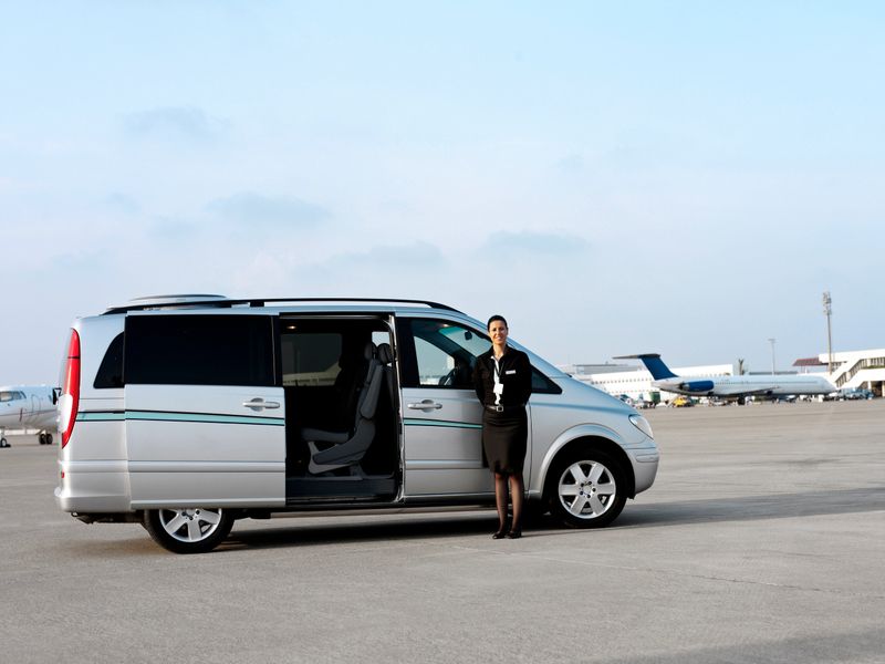 Personnel waiting beside a VIP shuttle service on airport platform
